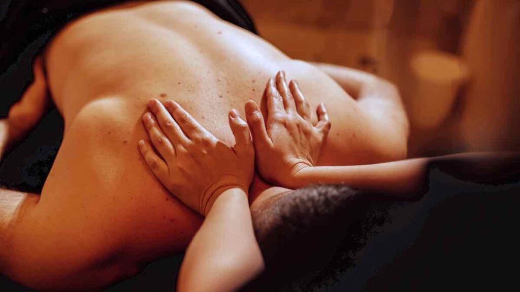 Thai massage and pressure points by an experienced therapist on a man upper back in aluxury villa