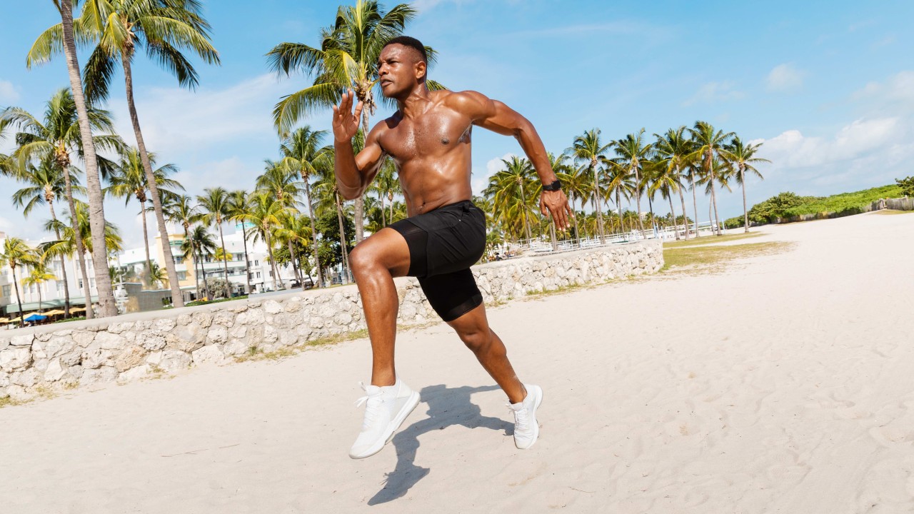 elite sports athlete running on private beach